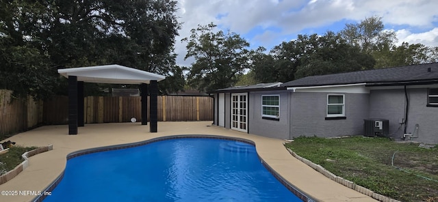 view of swimming pool featuring central air condition unit