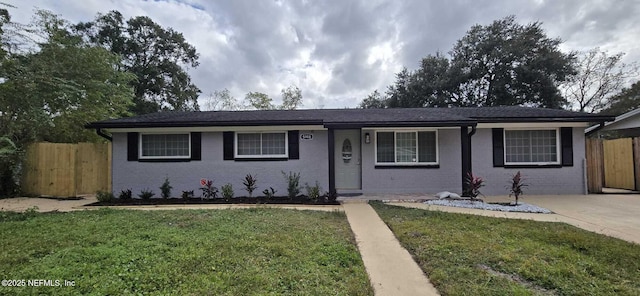 ranch-style house with covered porch and a front lawn