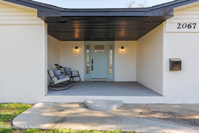 doorway to property featuring covered porch