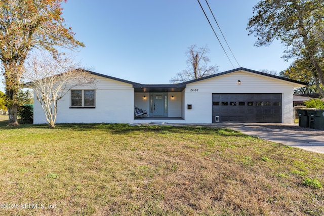 single story home with a garage and a front lawn