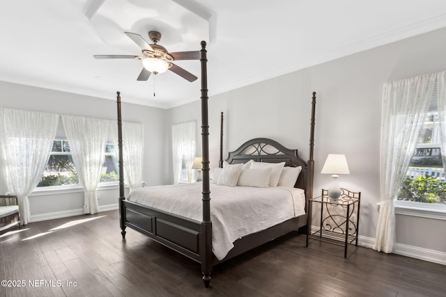 bedroom featuring dark wood-type flooring, crown molding, and multiple windows