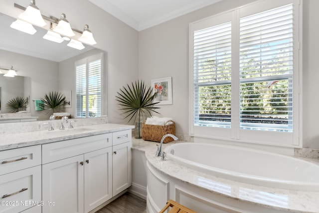 bathroom featuring crown molding, a bathing tub, and vanity