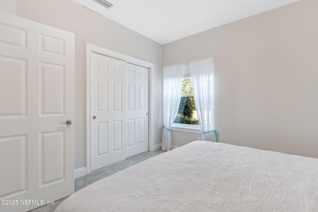 carpeted bedroom with a closet