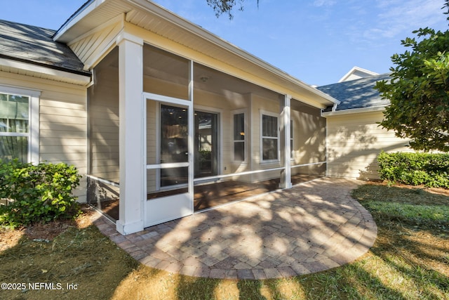 exterior space with a patio area and a sunroom