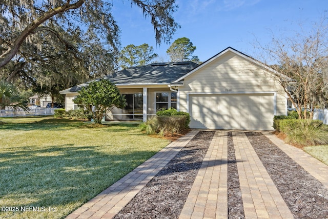 ranch-style home featuring a garage and a front lawn