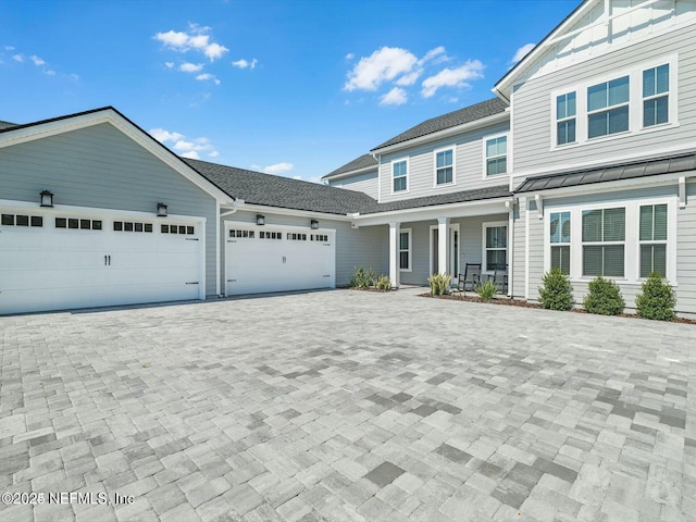 view of front of house with a porch and a garage