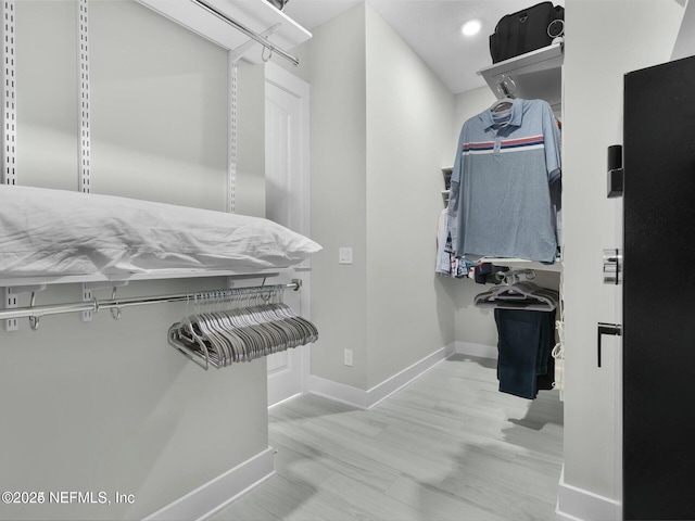 spacious closet featuring light hardwood / wood-style flooring