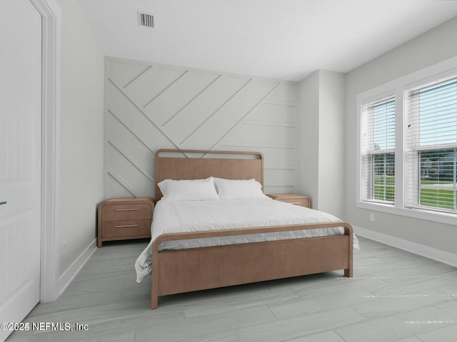 bedroom featuring wood walls