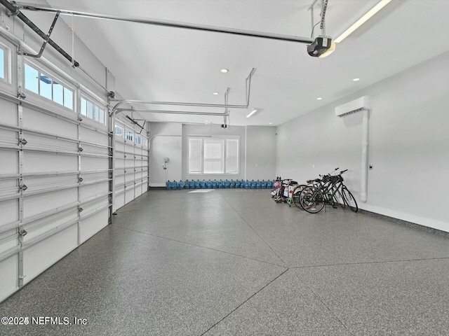 garage with a wall mounted air conditioner and a garage door opener