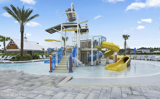 view of playground with pool water feature and a community pool