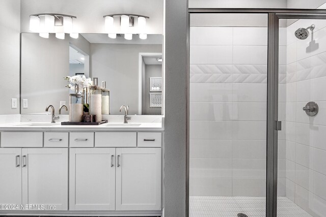 bathroom featuring vanity and a shower with shower door