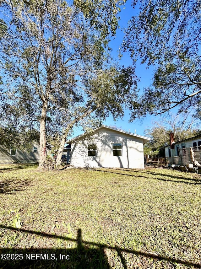 view of property exterior featuring a lawn