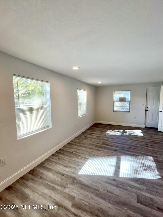 unfurnished room featuring dark wood-type flooring