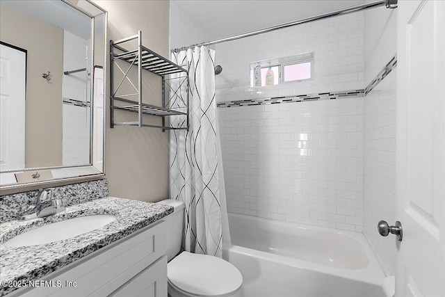 full bathroom featuring shower / bathtub combination with curtain, vanity, and toilet