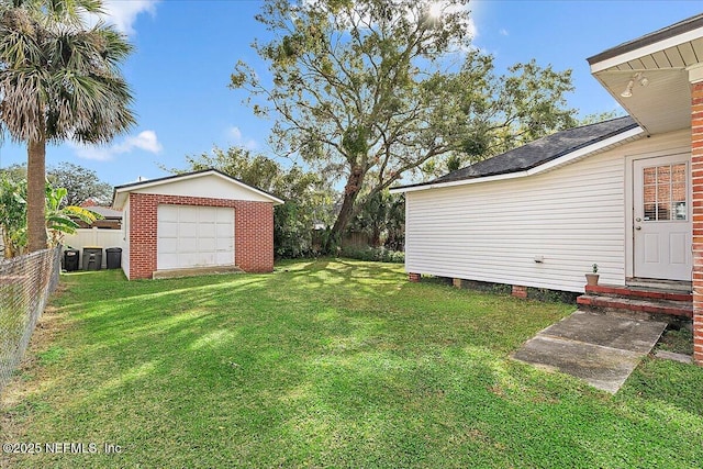 view of yard featuring an outbuilding and a garage