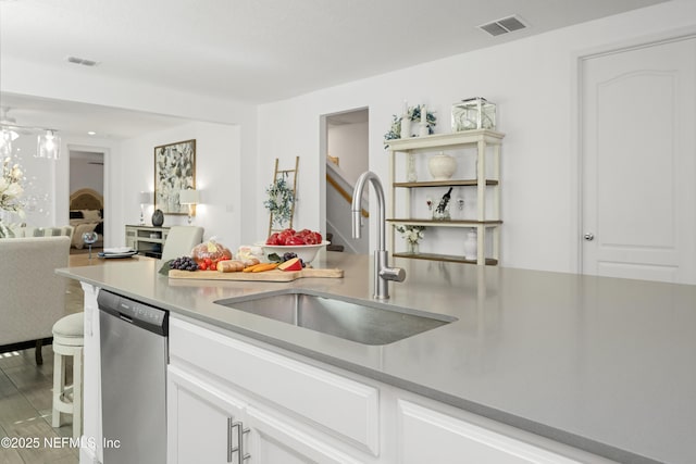 kitchen with dishwasher, light wood-type flooring, white cabinetry, and sink