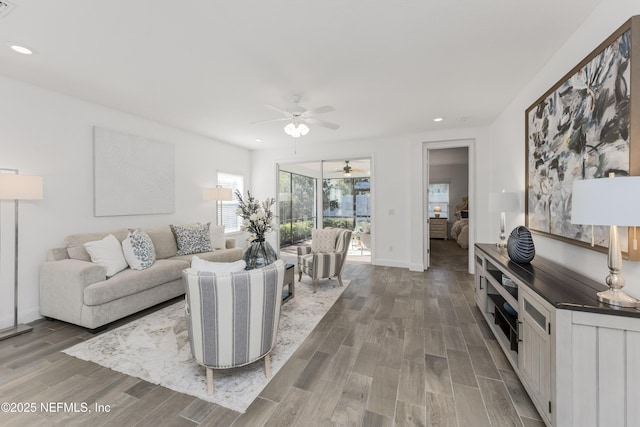 living room with light hardwood / wood-style floors and ceiling fan