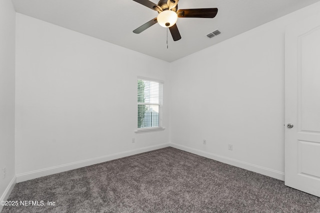 carpeted spare room with ceiling fan