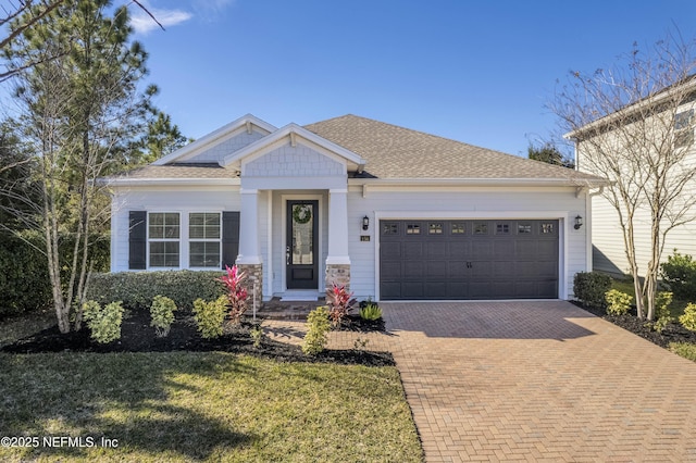 view of front of home featuring a garage and a front lawn