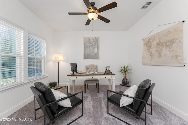 carpeted office featuring ceiling fan