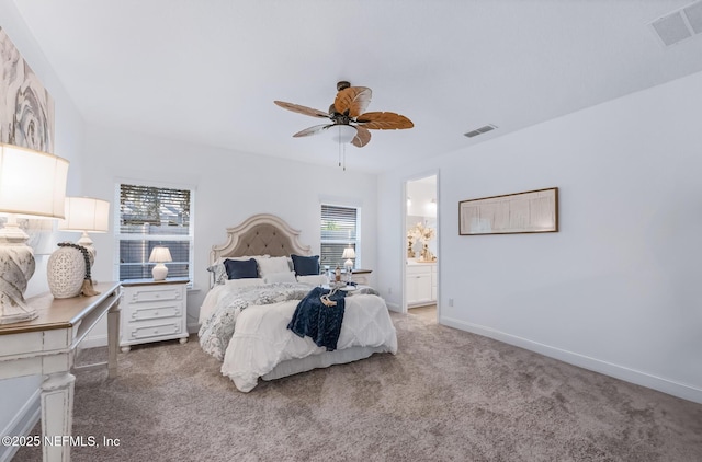 carpeted bedroom with ensuite bath and ceiling fan