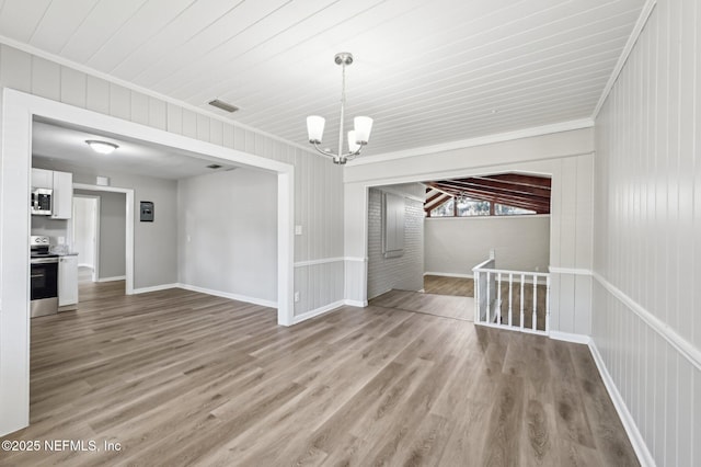 interior space featuring a notable chandelier, light hardwood / wood-style floors, and ornamental molding