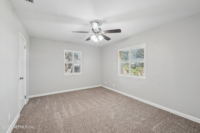 carpeted empty room featuring ceiling fan