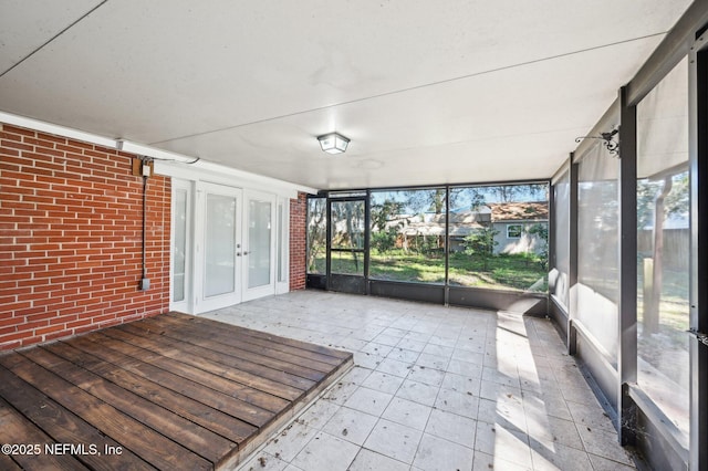 unfurnished sunroom with french doors