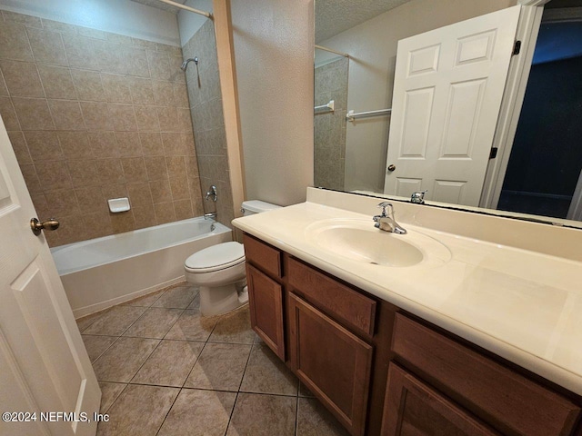 full bathroom featuring tile patterned floors, vanity, toilet, and tiled shower / bath