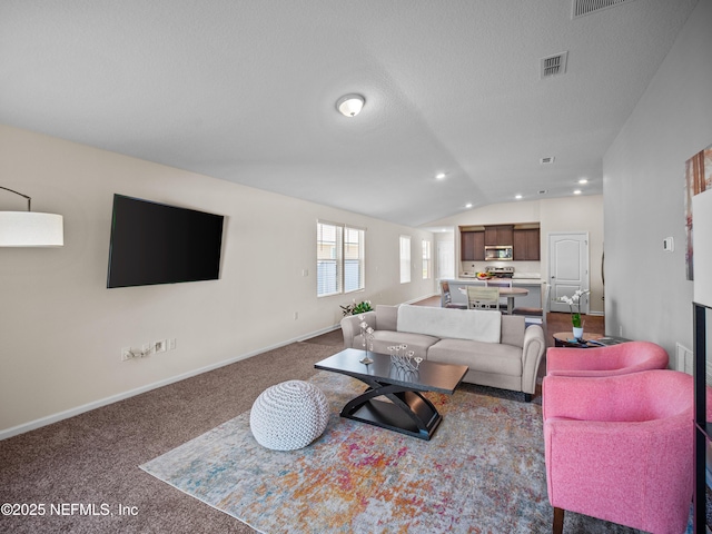 carpeted living room with lofted ceiling