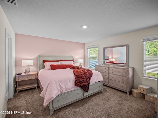 bedroom with carpet flooring and a textured ceiling