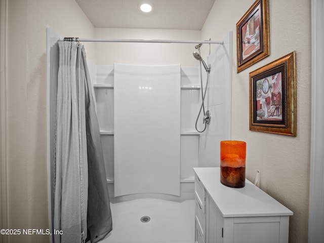 bathroom featuring curtained shower and vanity