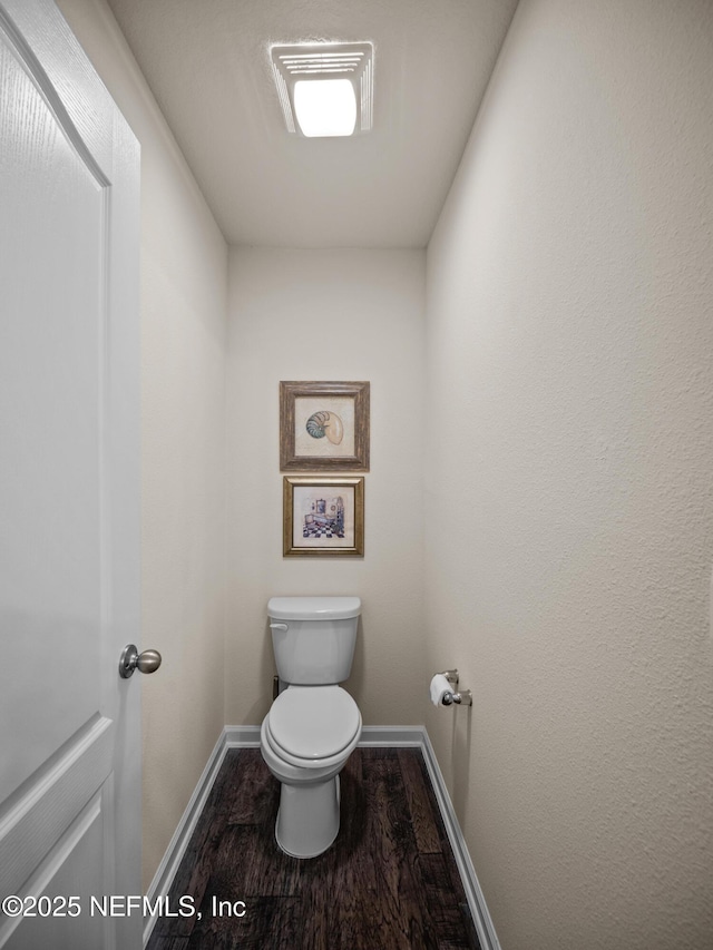 bathroom with toilet and hardwood / wood-style flooring