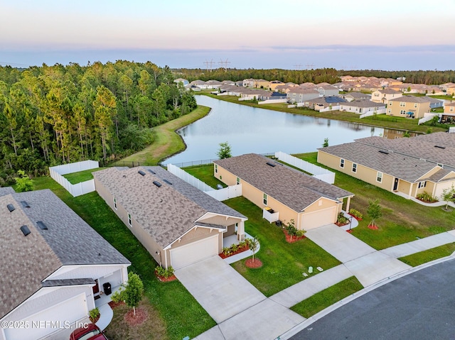 aerial view at dusk with a water view