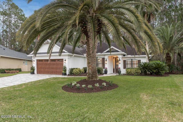 view of front of house featuring a front lawn and a garage