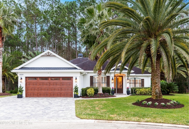 view of front of house with a front yard and a garage