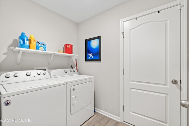 laundry area featuring washing machine and dryer and light wood-type flooring