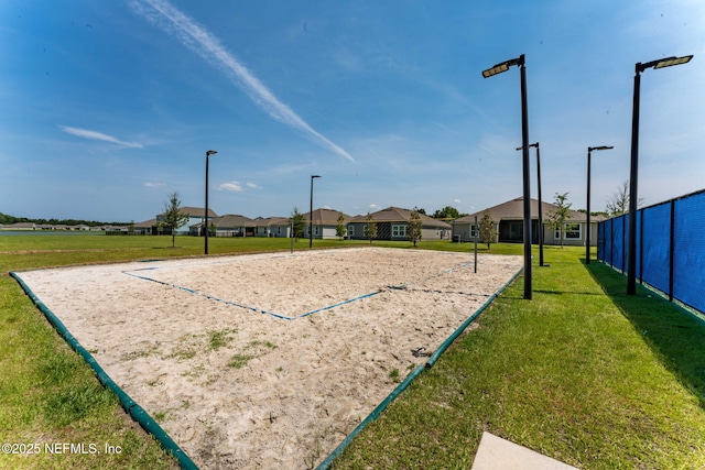 view of home's community with a yard and volleyball court