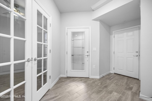 interior space with light hardwood / wood-style floors and french doors