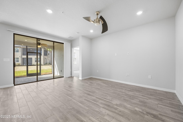 spare room with ceiling fan and light hardwood / wood-style flooring