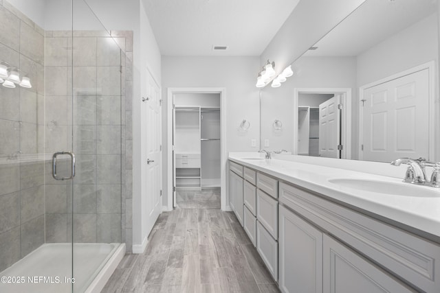 bathroom with vanity, hardwood / wood-style floors, and walk in shower