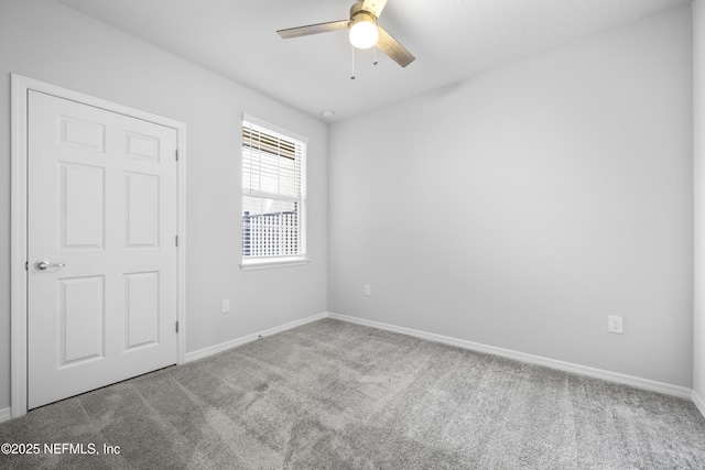 carpeted empty room featuring ceiling fan