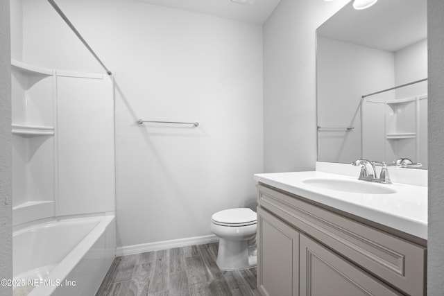 full bathroom with vanity, toilet, shower / bath combination, and hardwood / wood-style floors