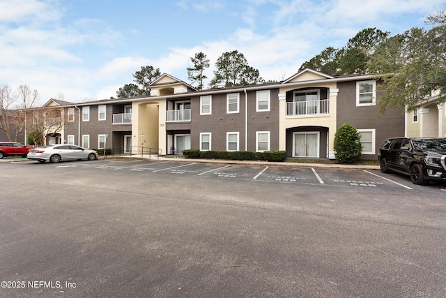 view of property featuring uncovered parking