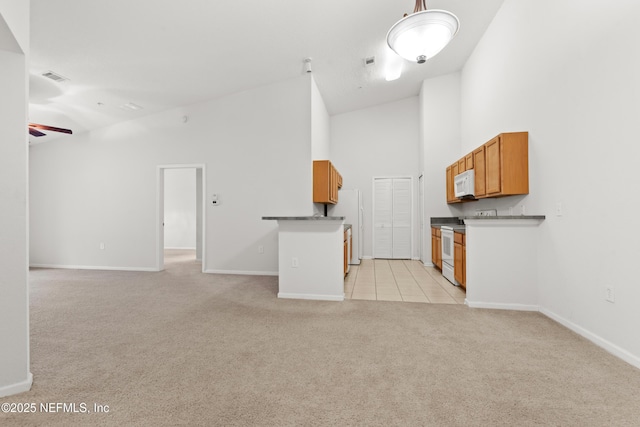 kitchen featuring light colored carpet, visible vents, open floor plan, high vaulted ceiling, and white appliances