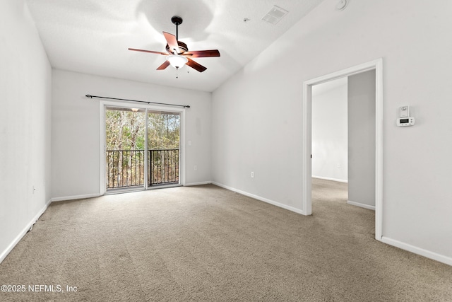 spare room featuring light colored carpet, ceiling fan, and lofted ceiling