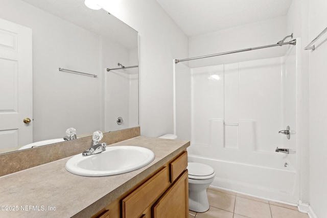 bathroom with  shower combination, vanity, toilet, and tile patterned floors