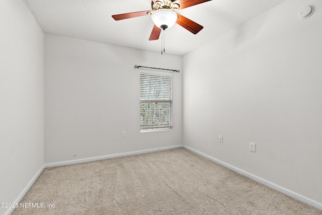 spare room featuring ceiling fan, a textured ceiling, carpet flooring, and baseboards