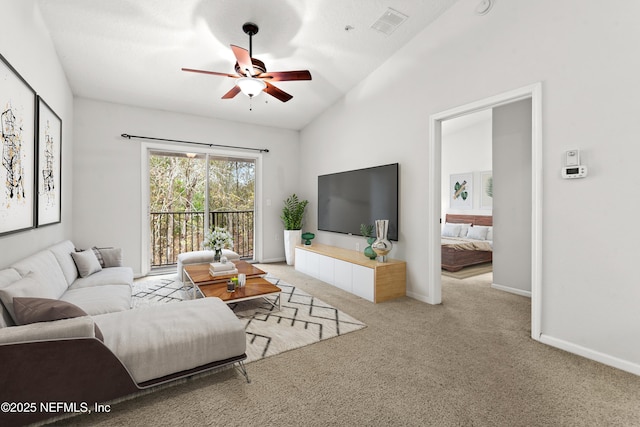 carpeted living area with vaulted ceiling, visible vents, ceiling fan, and baseboards