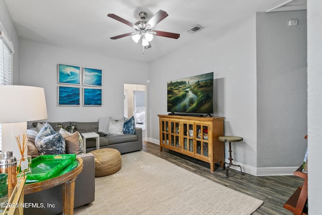 living room featuring ceiling fan and hardwood / wood-style flooring